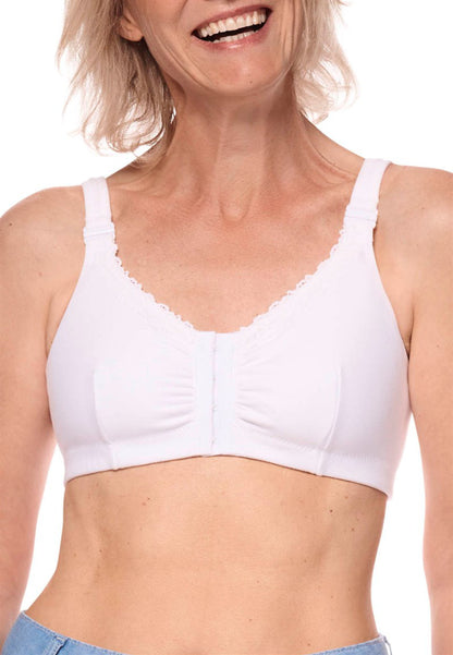 Woman wearing a white bra against a plain background