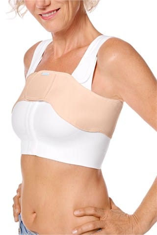 Amoena anatomical compression belt in rose nude worn with surgical bra showing optimal positioning for recovery