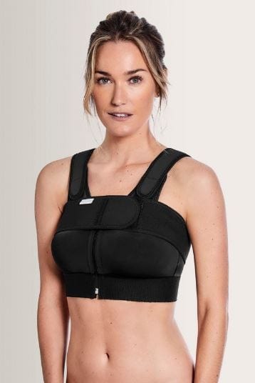 Amoena compression belt in black worn over surgical bra demonstrating proper positioning for implant stabilization